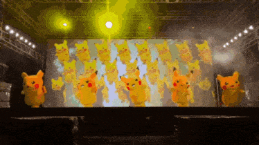 a group of pikachu are dancing on a stage in front of a large screen