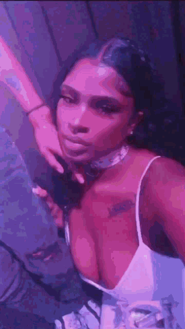 a woman in a white dress is taking a selfie with a person .