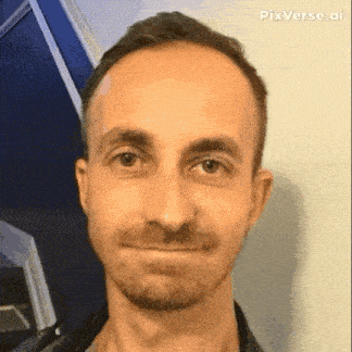 a close up of a man 's face with a beard making a funny face .