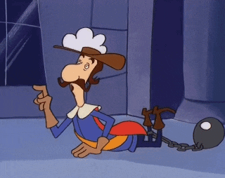 a cartoon character is laying on the floor with a ball and chain around his ankle