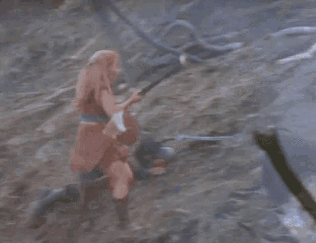 a group of people are fighting each other in a field