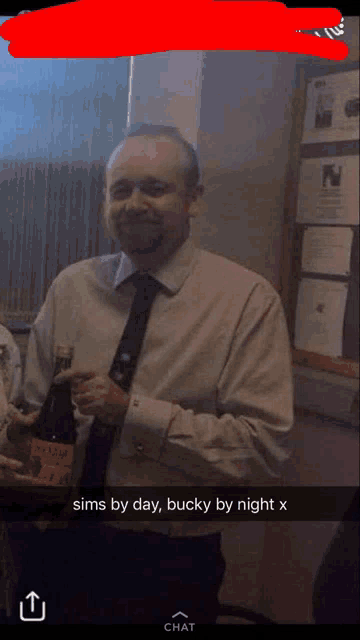 a man in a suit and tie is holding a bottle of wine