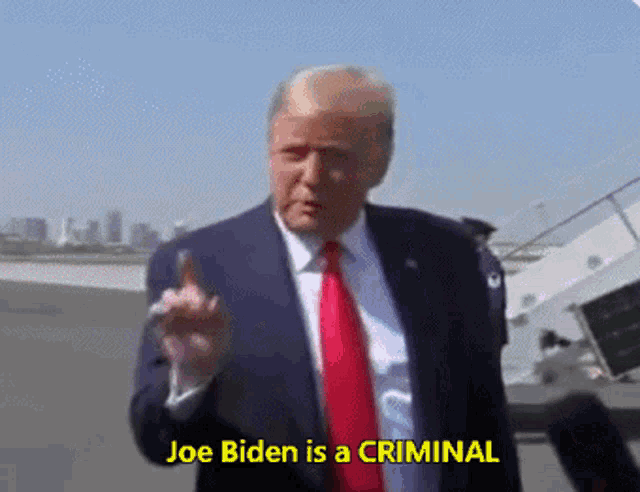 donald trump says joe biden is a criminal while giving the middle finger