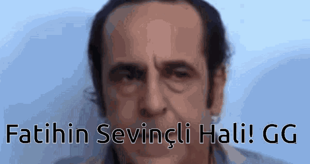 a close up of a man 's face with the words fatihin sevingli hali gg below it