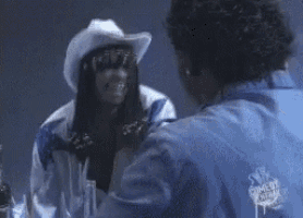a man in a blue jacket with the word comedy on the back