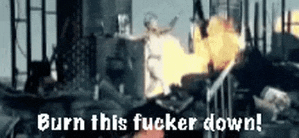 a statue of justice is burning in a fire with the words `` burn this fucker down '' .