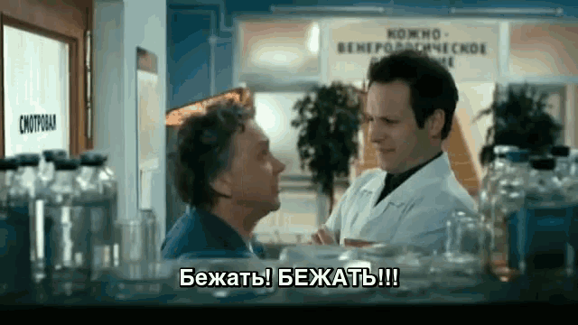 a man in a lab coat is talking to another man in front of a sign that says " smotrobaa "