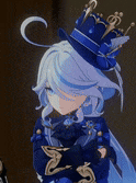a girl wearing a blue hat with a crown on it is standing in a room .