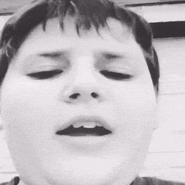 a black and white photo of a person with their mouth open