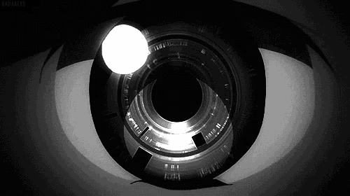 a black and white photo of a person 's eye