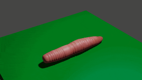 a worm is laying on a green surface