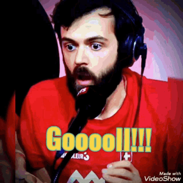 a man with a beard is wearing headphones and a red shirt that says goool !!!