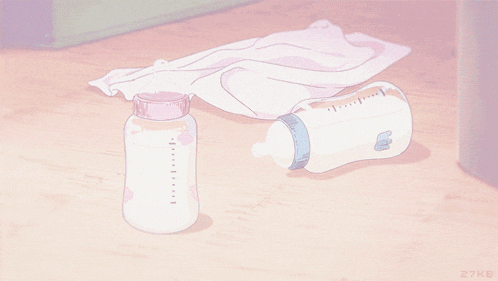 a pink and white bottle with the letter b on it sits on the floor