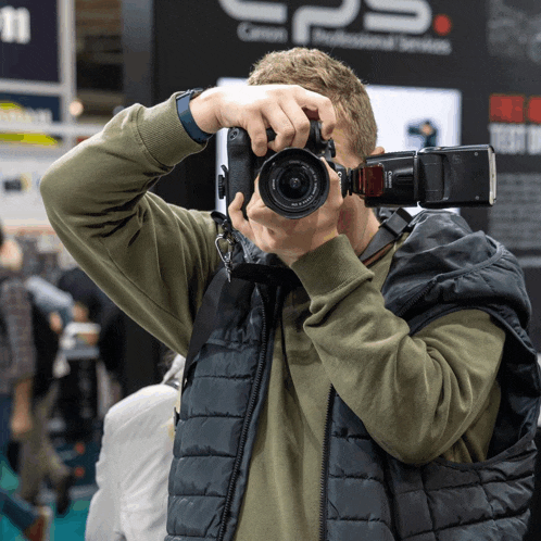 a man is taking a picture in front of a sign that says cps