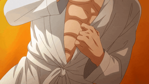 a close up of a man 's chest with a white robe on