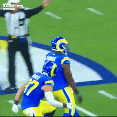 two los angeles rams football players celebrate a touchdown
