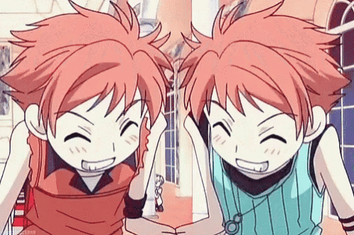 a couple of anime twins are standing next to each other .