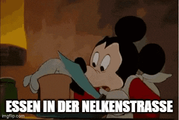 a cartoon of mickey mouse eating a piece of paper with the words essen in der nelkenstrasse below him .