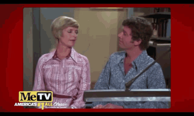 a man and a woman are talking in front of a microphone with the words me tv on the bottom