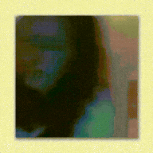 a painting of a woman 's face is framed in a yellow frame