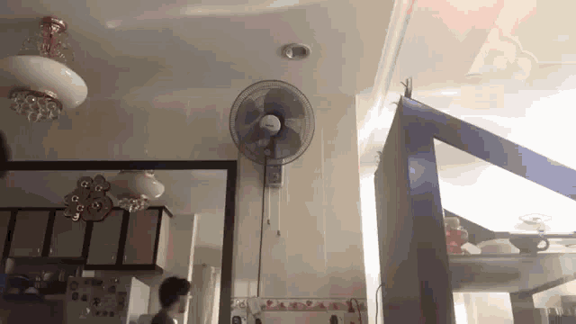 a wall fan is hanging from the ceiling in a kitchen