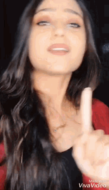 a woman is making a peace sign with her fingers