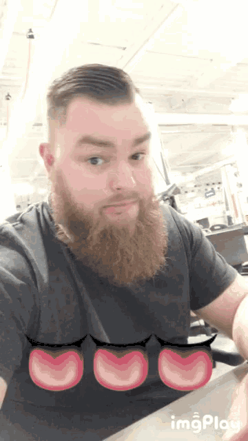 a man with a beard is making a funny face with his tongue out
