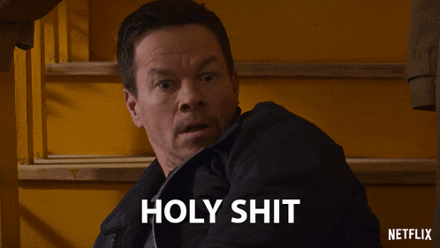 a man with a surprised look on his face and the words holy shit below him