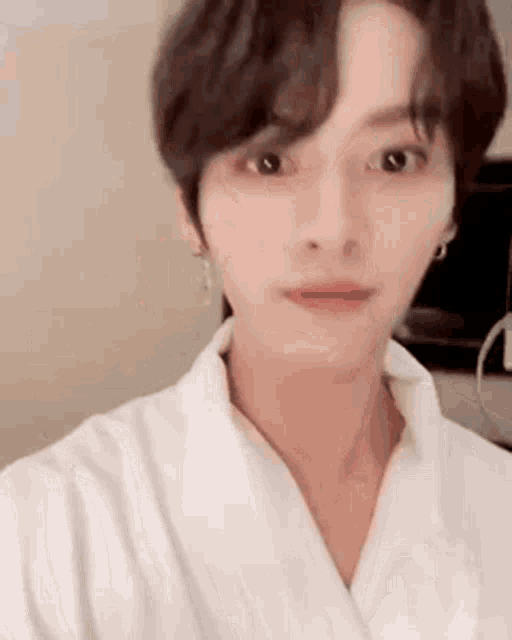 a young man is taking a selfie with a white robe on .