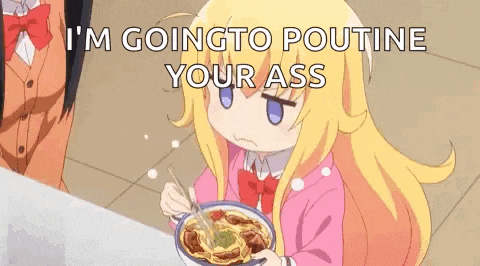a little girl is sitting at a table eating a bowl of spaghetti .