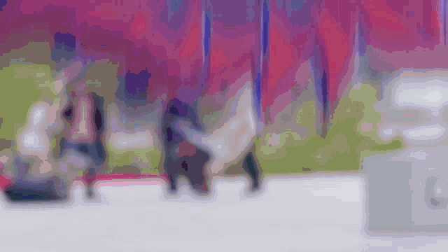 a blurry picture of a group of people walking in a park