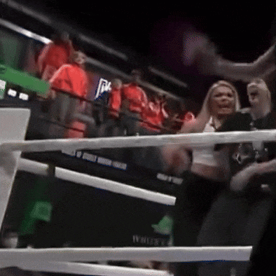 a woman stands in a boxing ring with a sign that says intercontinental on it