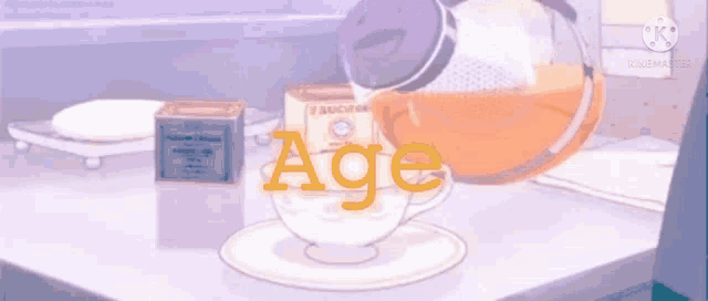 a cup of tea is being poured into a saucer with the word age written on it .