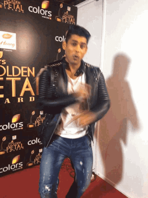 a man is dancing in front of a sign that says golden petal