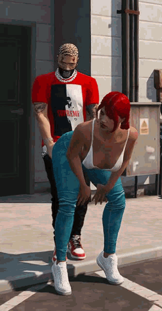 a man and a woman are standing next to each other on the sidewalk .