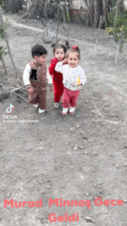 three children are walking down a dirt road with the words murad minnos gece geldi
