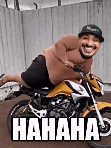 a man is riding a motorcycle with the words hahaha written on the side