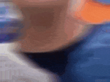a blurry picture of a person 's face with a blue shirt