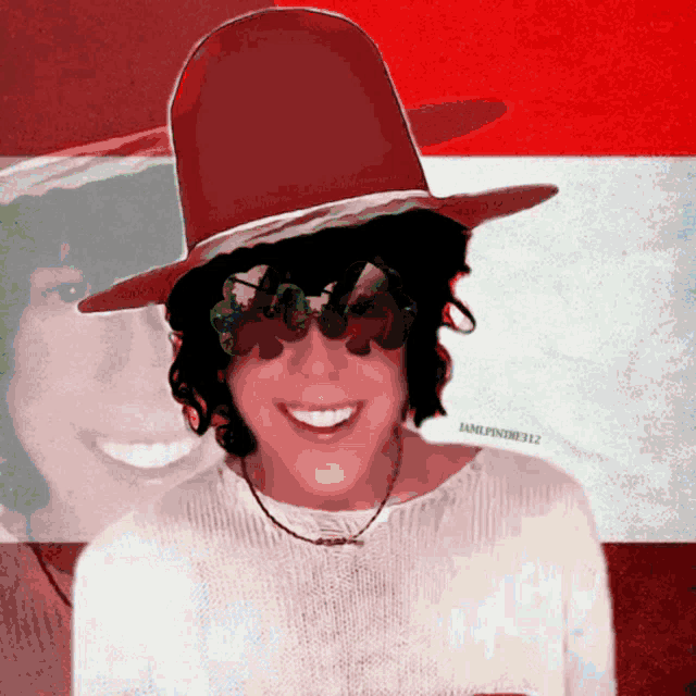 a woman wearing a red hat and sunglasses is smiling in front of a red and white flag