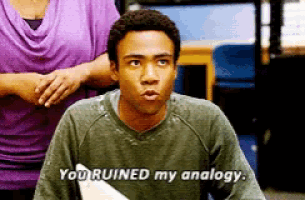 a man is sitting at a desk and says you ruined my analogy