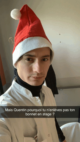 a man wearing a santa hat with the caption mais quentin pourquoi tu n ' enleves pas ton bonnet en stage