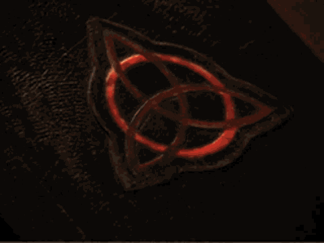 a close up of a black object with red circles