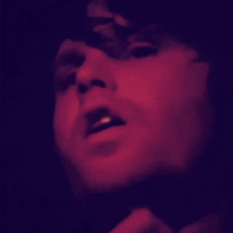 a close up of a person 's face with a purple background