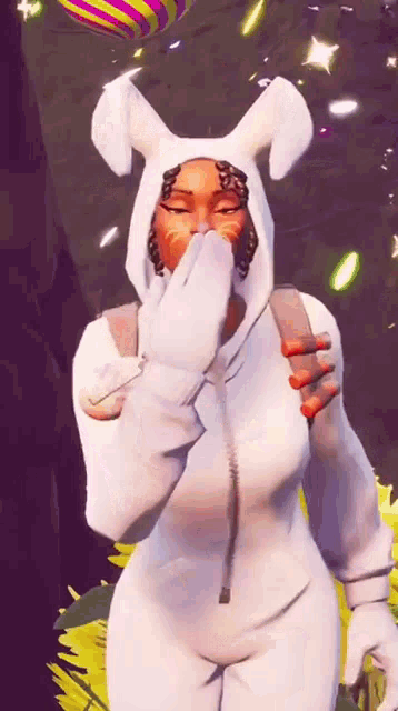 a woman in a white bunny costume is covering her mouth with her hands .