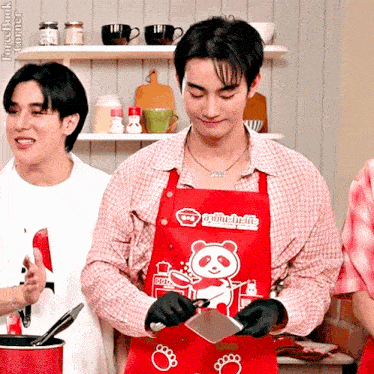 a man in a red apron with a panda on it