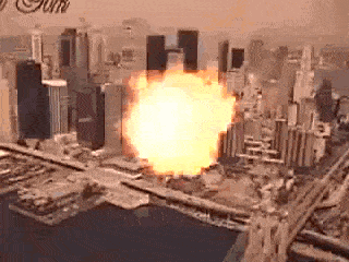 an aerial view of a city with a huge fireball coming out of it