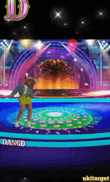 a woman is dancing on a stage with the word angd on the bottom right