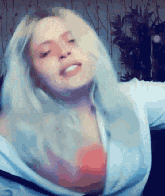 a close up of a woman 's face with a blurred background