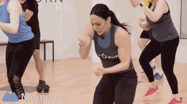 a woman in a momento shirt is dancing
