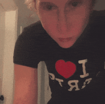 a person wearing a black shirt that says i heart rap on it